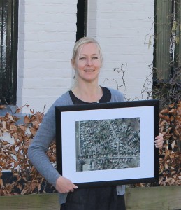 FIGURE 1. One of Dotka’s early non-GIS customers poses here with a framed picture of her house and neighborhood. Initially focusing on the consumer market, Dotka became a popular site for accessing maps and historic imagery for areas of interest.