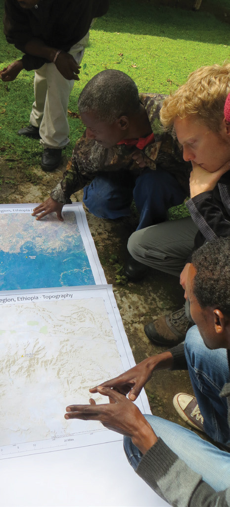 FIGURE 3. Participatory mapping in the Bale Mountains of Ethiopia using satellite imagery and local experts. Courtesy of M. Laituri.